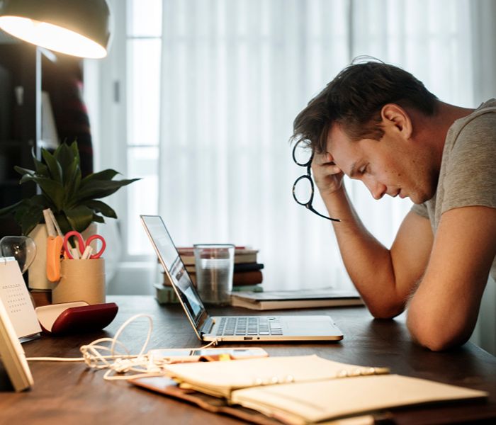 Man struggling with concentrating at work
