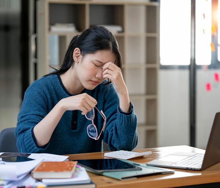 Woman experiencing fatigue at work