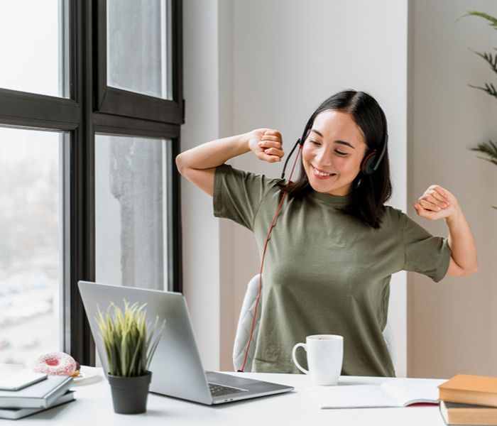 Woman happily stretching between work