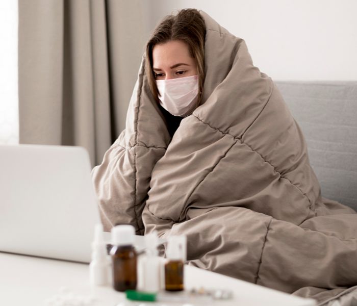 Sick woman wearing facemask