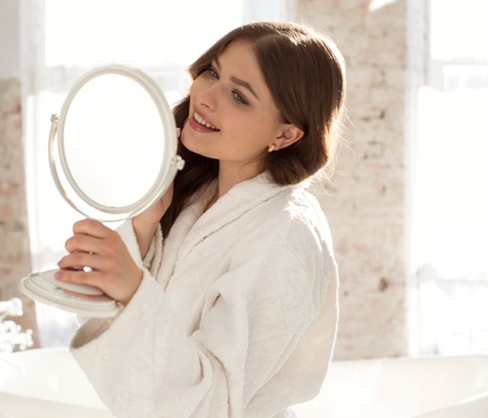 Woman checking herself at the mirror